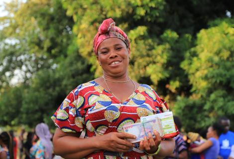 Charity, excited after she received the cash support from ActionAid
